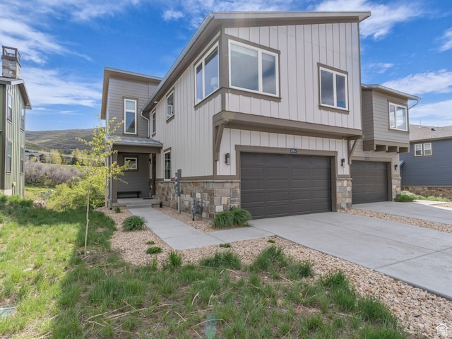 12852 N Belaview Way, Hideout, UT 84036 - view of front facade with stone siding, board and batten siding, an attached garage, and driveway