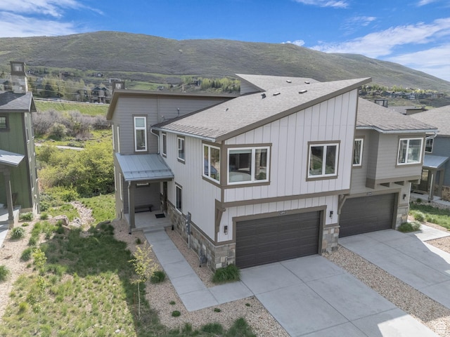 12852 N Belaview Way, Hideout, UT 84036 - view of front of property featuring stone siding, a garage, roof with shingles, and a mountain view