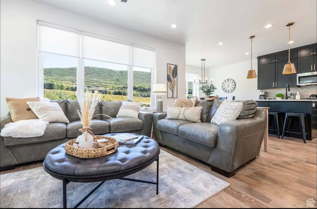12852 N Belaview Way, Hideout, UT 84036 - living room with light wood-style flooring, recessed lighting, and a chandelier
