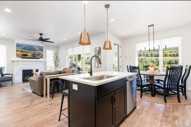 12852 N Belaview Way, Hideout, UT 84036 - kitchen with a sink, stainless steel dishwasher, ceiling fan, light wood-style flooring, and light countertops