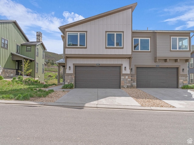 12852 N Belaview Way, Hideout, UT 84036 - view of front of home featuring stone siding, a garage, driveway, and board and batten siding