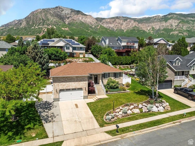 494 E 3525 N, North Ogden, UT 84414 - view of front facade with concrete driveway, a residential view, a mountain view, stairs, and a front yard