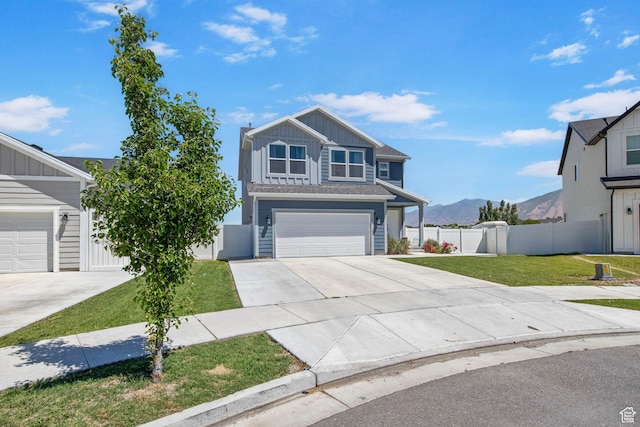 432 W 1470 N, Tooele, UT 84074 - view of front of property featuring board and batten siding, driveway, a mountain view, and an attached garage