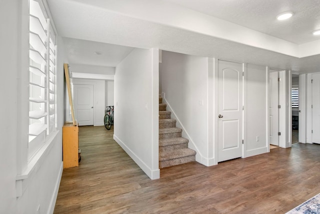 432 W 1470 N, Tooele, UT 84074 - below grade area with wood finished floors, stairway, and a textured ceiling