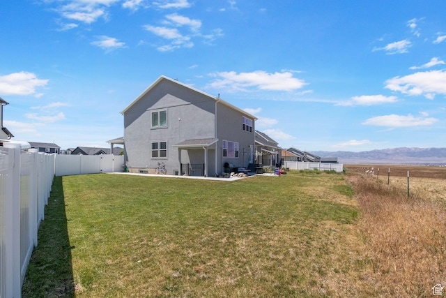 432 W 1470 N, Tooele, UT 84074 - rear view of house featuring a patio area, a fenced backyard, stucco siding, and a mountain view