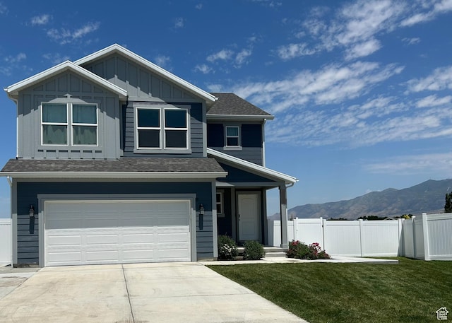 432 W 1470 N, Tooele, UT 84074 - view of front facade with a mountain view, driveway, an attached garage, board and batten siding, and roof with shingles