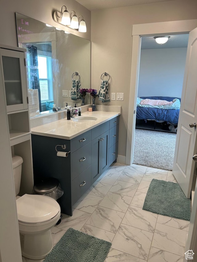 432 W 1470 N, Tooele, UT 84074 - bathroom with marble look tiles, vanity, toilet, and ensuite bathroom