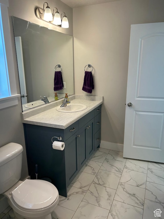 432 W 1470 N, Tooele, UT 84074 - bathroom featuring vanity, toilet, marble finish floors, and baseboards