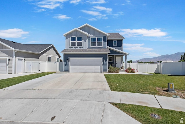 432 W 1470 N, Tooele, UT 84074 - view of front of property with driveway, board and batten siding, a gate, an attached garage, and a mountain view