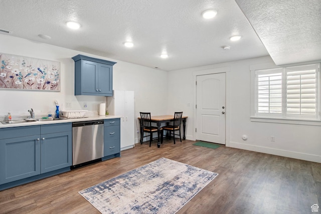 432 W 1470 N, Tooele, UT 84074 - kitchen with dishwasher, a textured ceiling, blue cabinets, wood finished floors, and light countertops