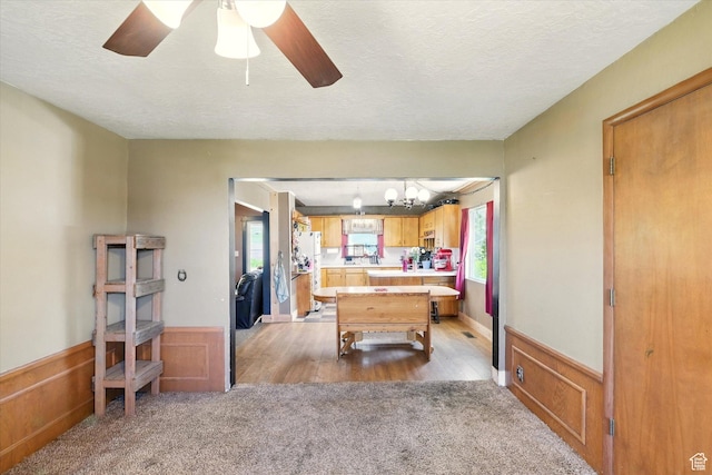 1411 E 13000 N, Cove, UT 84320 - recreation room with light carpet, wainscoting, a ceiling fan, a textured ceiling, and a chandelier