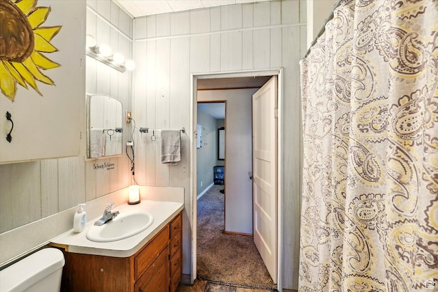 1411 E 13000 N, Cove, UT 84320 - full bathroom with vanity, toilet, wood walls, and a shower with shower curtain