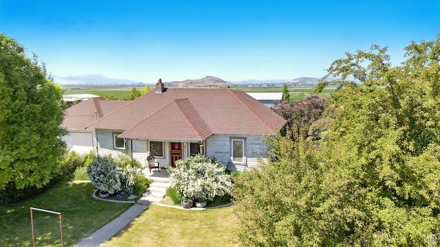 1411 E 13000 N, Cove, UT 84320 - view of front of property with a front yard, a chimney, and a mountain view