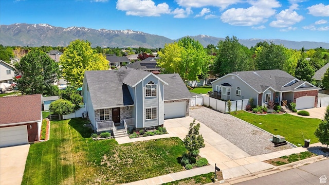2223 S Allison Way, Syracuse, UT 84075 - view of front of house with driveway, a mountain view, a residential view, and covered porch