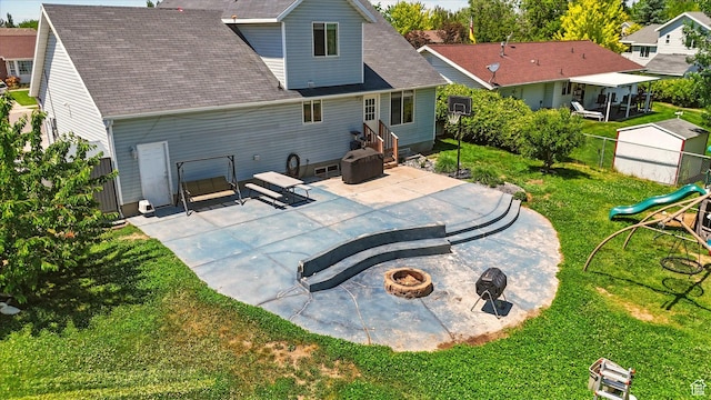 2223 S Allison Way, Syracuse, UT 84075 - rear view of house featuring an outdoor fire pit, a patio area, and a shingled roof
