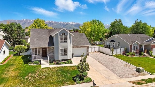 2223 S Allison Way, Syracuse, UT 84075 - view of front facade featuring driveway, an attached garage, a mountain view, and stone siding