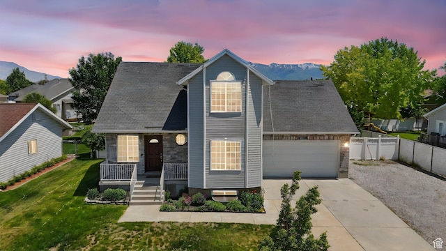 2223 S Allison Way, Syracuse, UT 84075 - view of front of property featuring driveway, covered porch, an attached garage, a mountain view, and a shingled roof