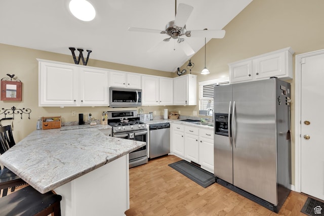 1127 W Monticello Ln, Murray, UT 84123 - kitchen featuring appliances with stainless steel finishes, a peninsula, white cabinetry, a ceiling fan, and high vaulted ceiling