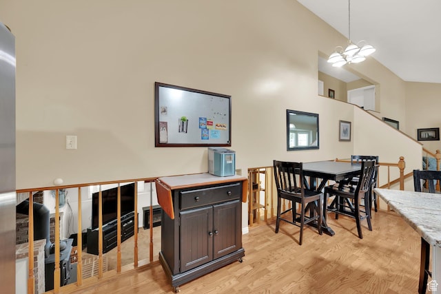 1127 W Monticello Ln, Murray, UT 84123 - dining space with light wood-style floors, a chandelier, and stairs