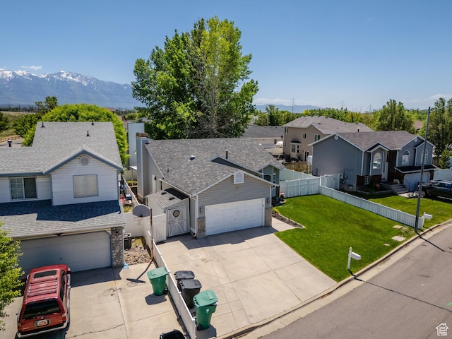 1127 W Monticello Ln, Murray, UT 84123 - view of front of property with concrete driveway, a mountain view, a residential view, roof with shingles, and a gate