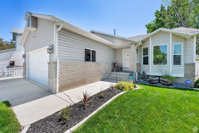 1127 W Monticello Ln, Murray, UT 84123 - view of front facade featuring an attached garage, driveway, a front yard, and brick siding