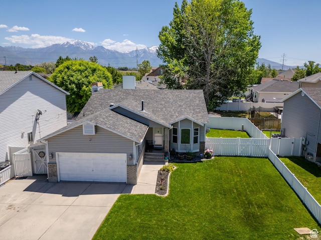 1127 W Monticello Ln, Murray, UT 84123 - view of front of property with a mountain view, brick siding, an attached garage, roof with shingles, and driveway