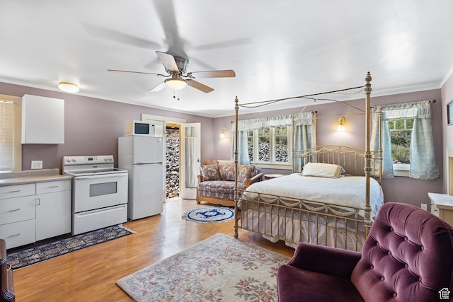 331 Beck St, Eureka, UT 84628 - bedroom featuring freestanding refrigerator, light wood-style flooring, crown molding, and ceiling fan
