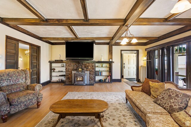 331 Beck St, Eureka, UT 84628 - living area featuring coffered ceiling, a wood stove, baseboards, wood finished floors, and beam ceiling