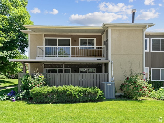 343 Peach Ln, Bountiful, UT 84010 - rear view of property featuring a balcony, central AC unit, a yard, and stucco siding