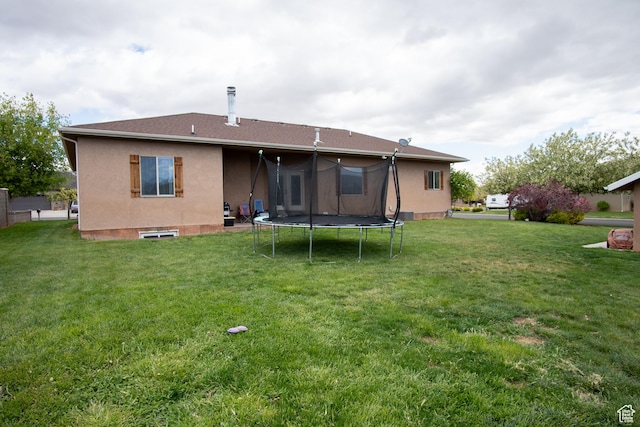 286 E 850 N, Richfield, UT 84701 - rear view of house with a trampoline, a yard, and stucco siding