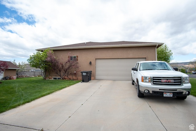 286 E 850 N, Richfield, UT 84701 - view of side of home featuring concrete driveway, an attached garage, stucco siding, and a yard