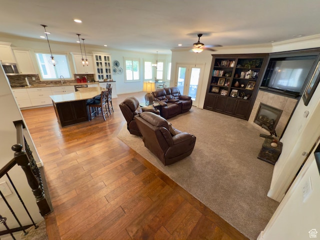 3322 N 750 E, Lehi, UT 84043 - living room with a tile fireplace, a ceiling fan, wood finished floors, and recessed lighting