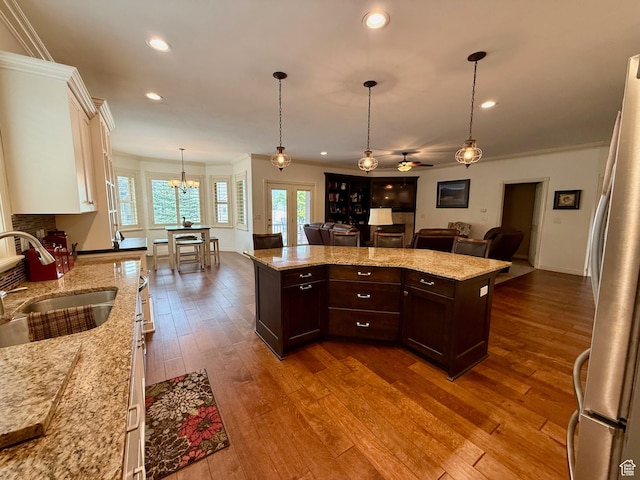 3322 N 750 E, Lehi, UT 84043 - kitchen featuring a sink, freestanding refrigerator, open floor plan, dark brown cabinetry, and white cabinets