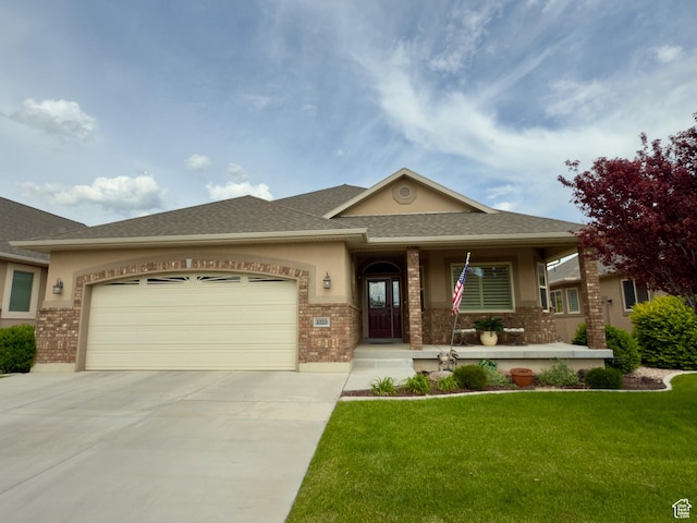 3322 N 750 E, Lehi, UT 84043 - prairie-style house with brick siding, concrete driveway, a garage, a front yard, and a shingled roof