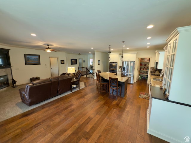 3322 N 750 E, Lehi, UT 84043 - living room featuring a tiled fireplace, dark wood-style flooring, recessed lighting, and ceiling fan