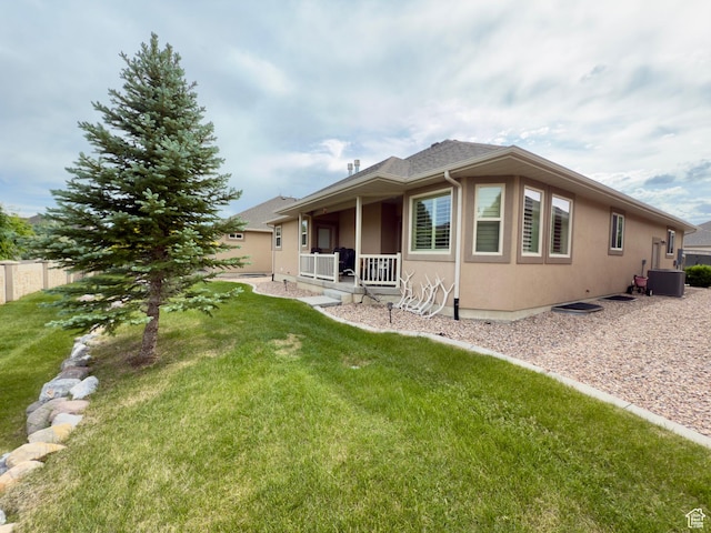 3322 N 750 E, Lehi, UT 84043 - back of property with stucco siding, a lawn, covered porch, and central air condition unit