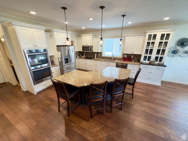 3322 N 750 E, Lehi, UT 84043 - kitchen featuring appliances with stainless steel finishes, a sink, a kitchen breakfast bar, white cabinets, and tasteful backsplash