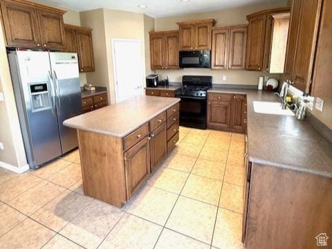 1093 S 1960 E, Spanish Fork, UT 84660 - kitchen featuring black appliances, a sink, a center island, brown cabinetry, and light tile patterned floors