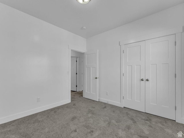 14569 S Bloom Dr W Unit L204, Herriman, UT 84096 - unfurnished bedroom with carpet flooring, baseboards, and a closet