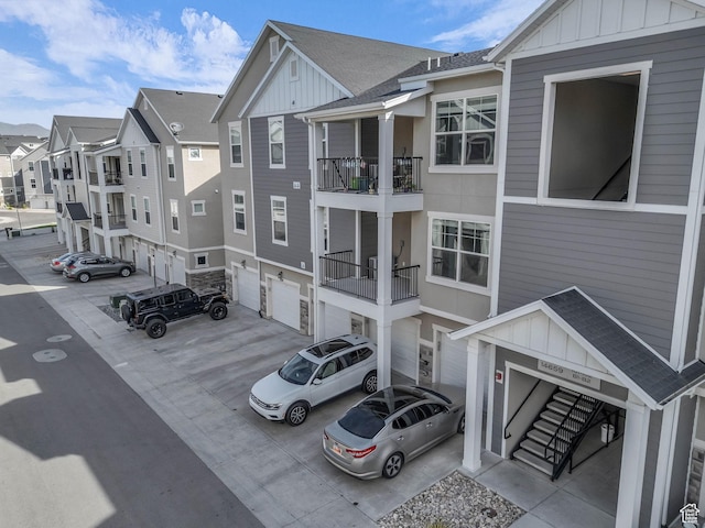 14569 S Bloom Dr W Unit L204, Herriman, UT 84096 - view of property with an attached garage, concrete driveway, and a residential view