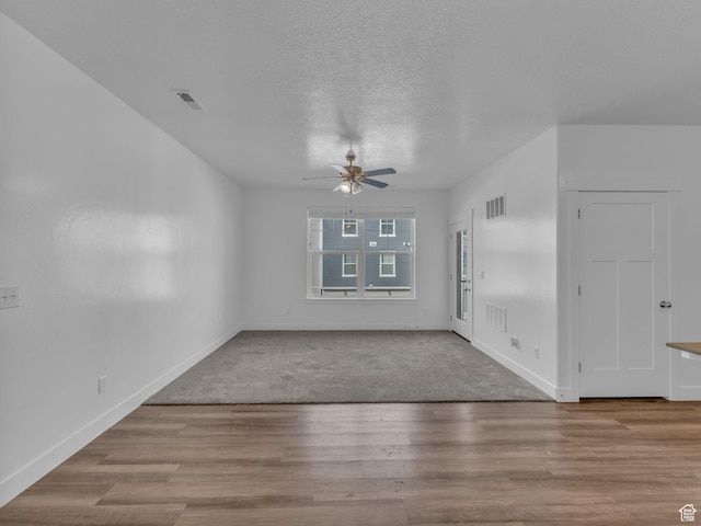 14569 S Bloom Dr W Unit L204, Herriman, UT 84096 - unfurnished room with a ceiling fan, baseboards, a textured ceiling, and wood finished floors