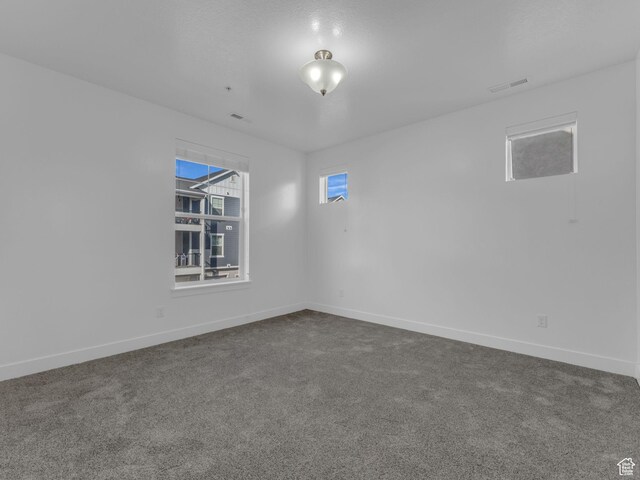 14569 S Bloom Dr W Unit L204, Herriman, UT 84096 - unfurnished room featuring dark colored carpet and baseboards