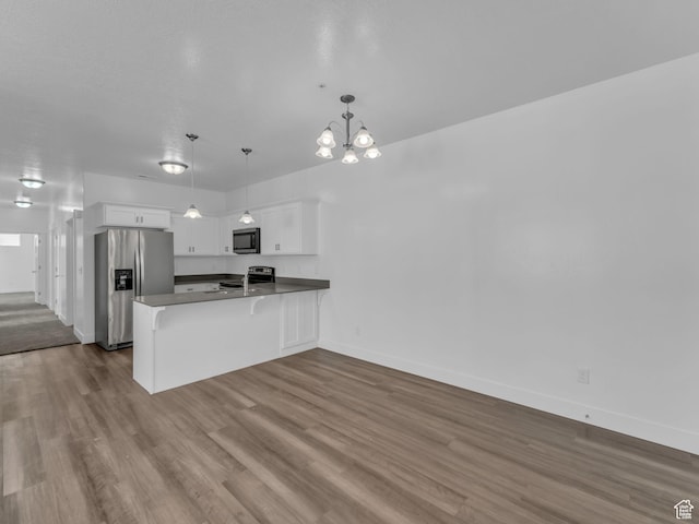 14569 S Bloom Dr W Unit L204, Herriman, UT 84096 - kitchen featuring appliances with stainless steel finishes, a peninsula, white cabinetry, and dark wood-type flooring