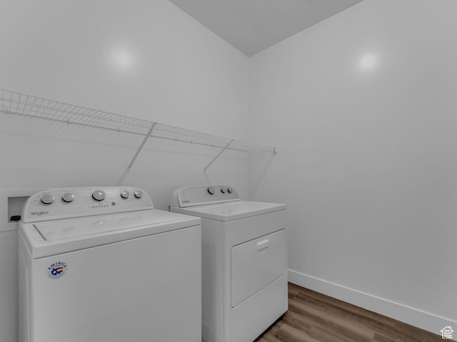 14569 S Bloom Dr W Unit L204, Herriman, UT 84096 - laundry area featuring washing machine and clothes dryer, wood finished floors, and baseboards