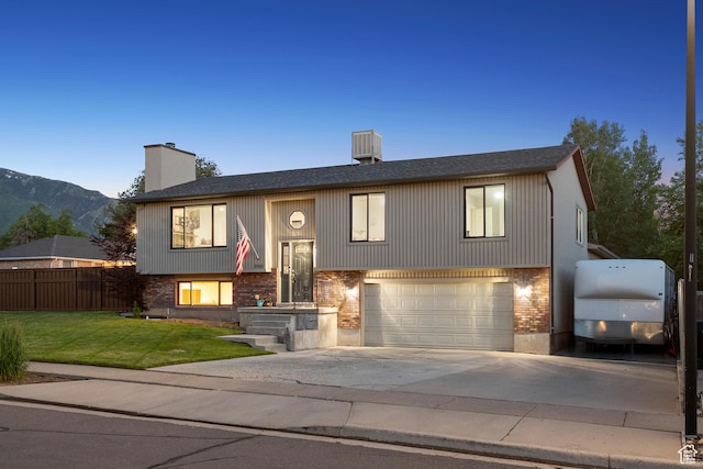 946 E 10715 S, Sandy, UT 84094 - raised ranch with a chimney, a garage, concrete driveway, brick siding, and a mountain view