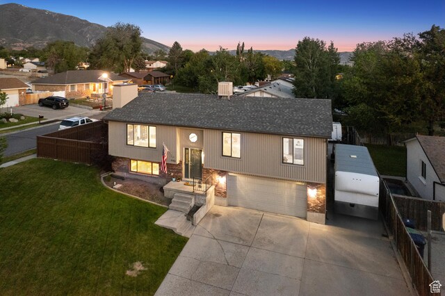 946 E 10715 S, Sandy, UT 84094 - split foyer home with a garage, roof with shingles, driveway, and a mountain view