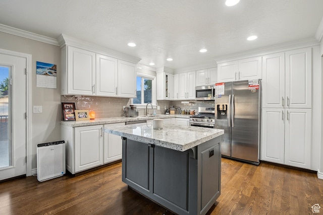 946 E 10715 S, Sandy, UT 84094 - kitchen featuring stainless steel appliances, a sink, white cabinets, dark wood-type flooring, and crown molding