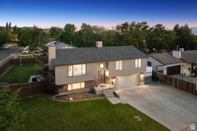 946 E 10715 S, Sandy, UT 84094 - raised ranch with driveway, a chimney, a shingled roof, and an attached garage