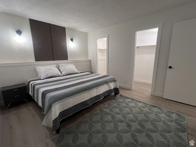 17 E 400 N Unit 27C, Bountiful, UT 84010 - bedroom with wood finished floors and a textured ceiling