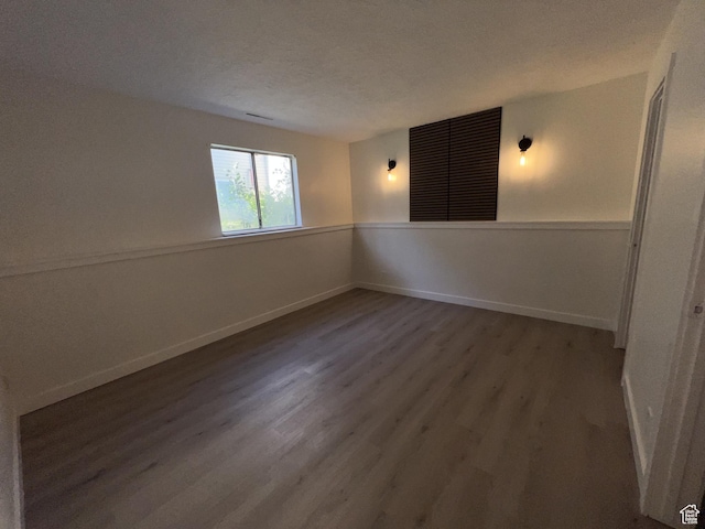17 E 400 N Unit 27C, Bountiful, UT 84010 - empty room with wood finished floors, baseboards, and a textured ceiling